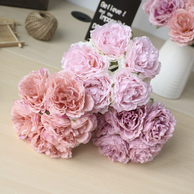 Rounded pink and mauve artificial peony bouquets displayed together