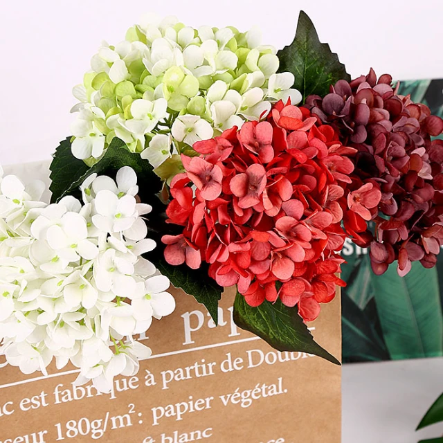 White, pale green, red and burgundy artificial hydrangea stems grouped together
