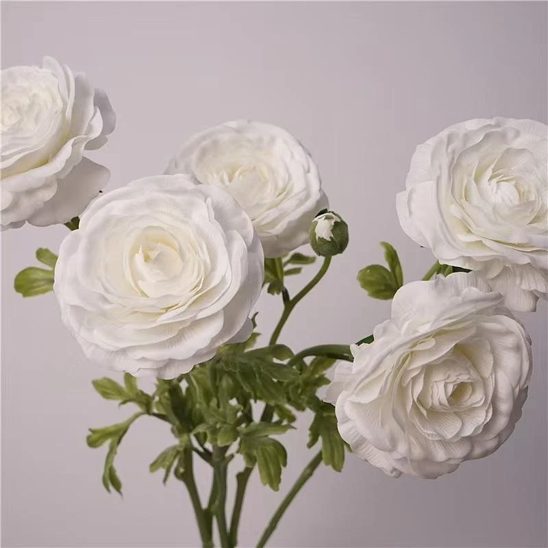 White artificial ranunculus blooms with green stems