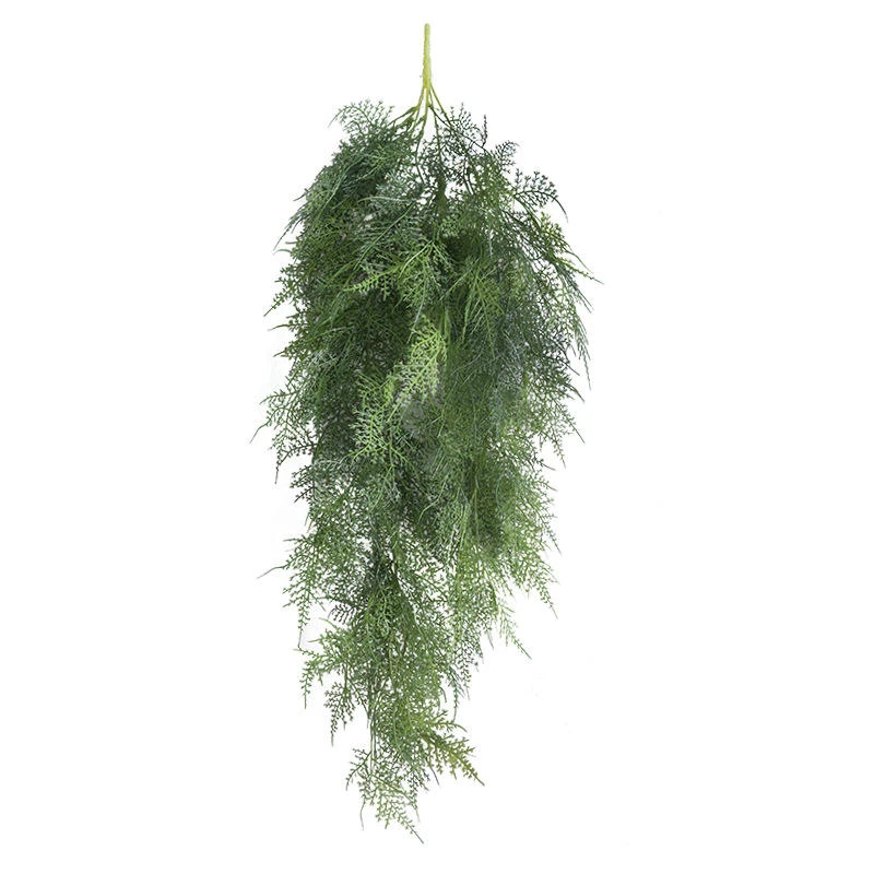 Long trailing green artificial foliage against a light background