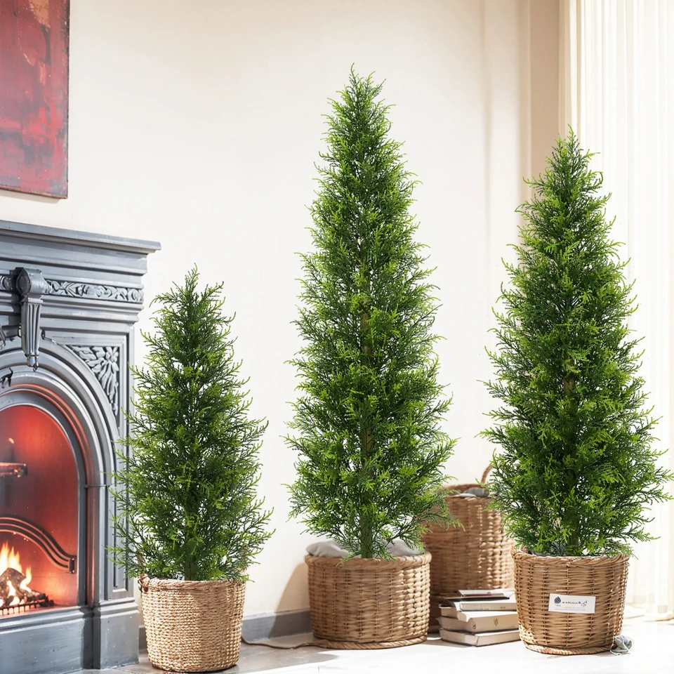 Three conical artificial evergreen trees displayed in woven containers