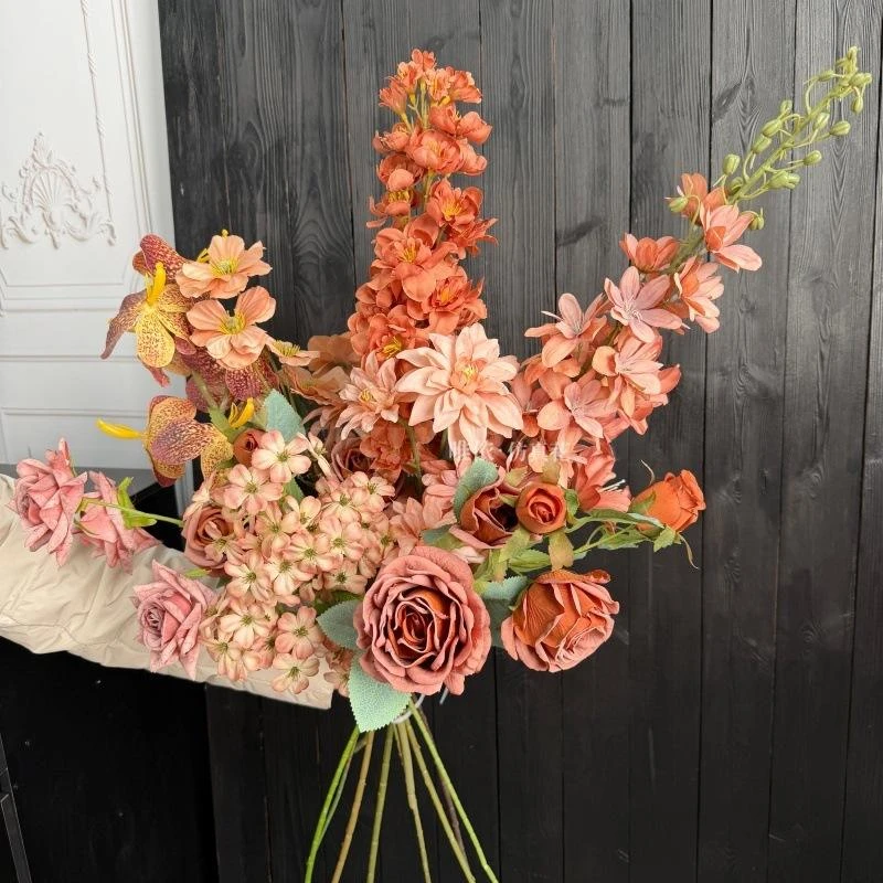 Autumn-colored artificial flowers gathered into a mixed bouquet