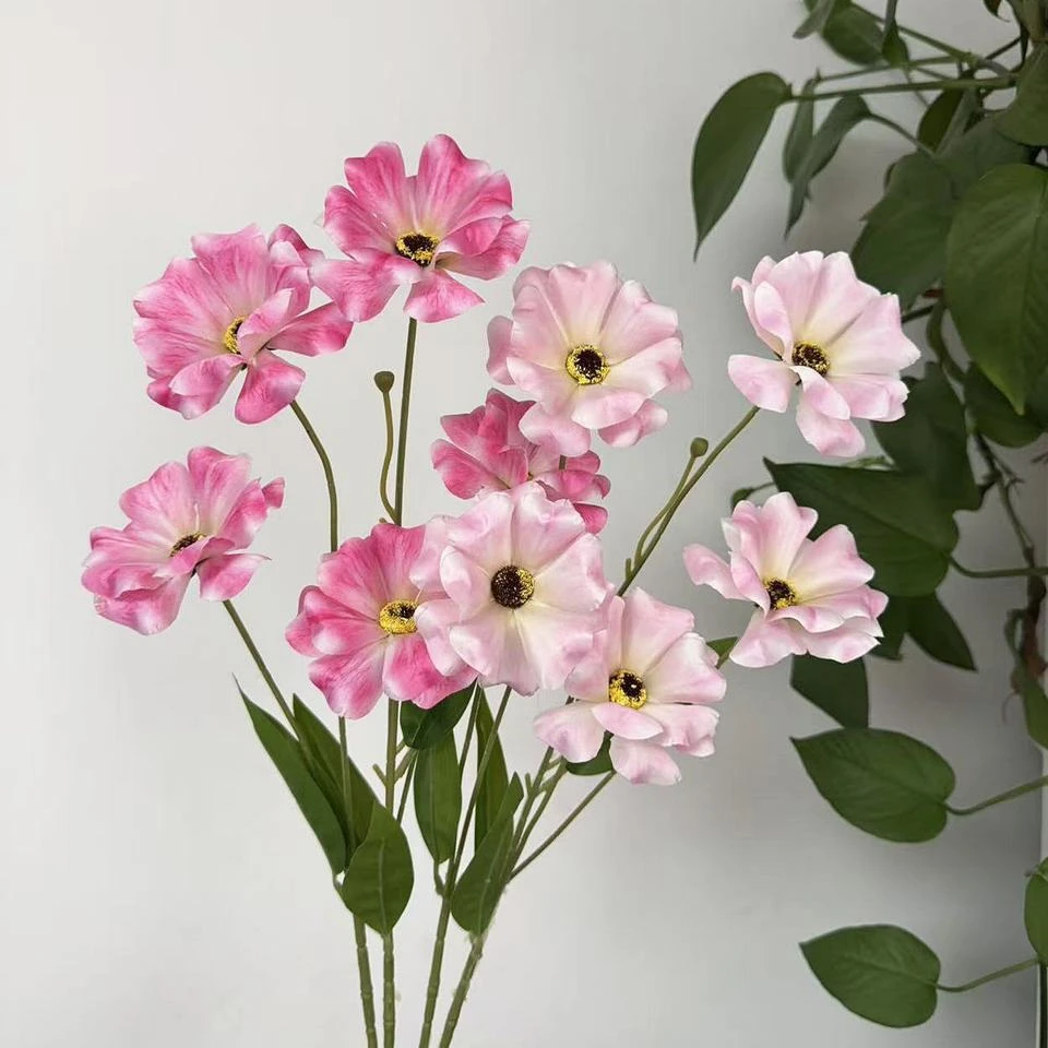 Pink artificial begonia flowers on tall stems